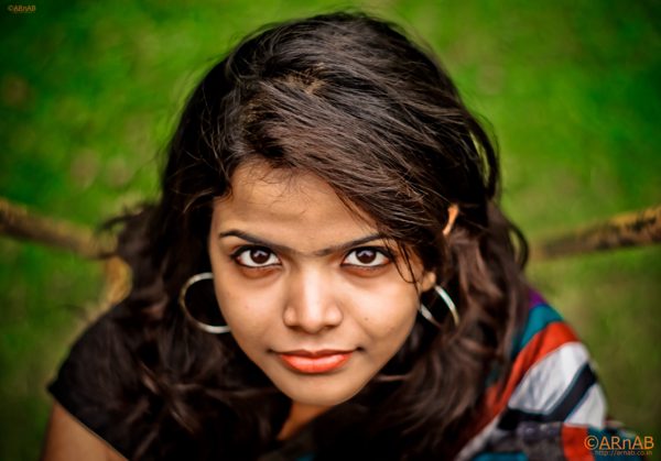 Portrait against green leaves