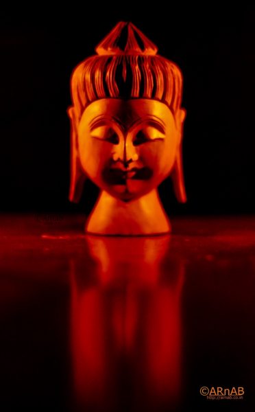 Buddha head in orange light